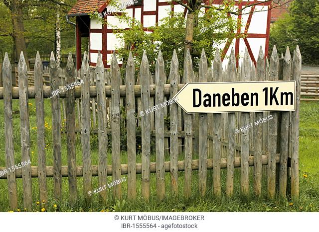 Town sign Daneben 1 km, German for off the mark or off target, funny road sign, Freilichtmuseum Hessenpark open-air museum, Neu-Anspach, Taunus mountain range