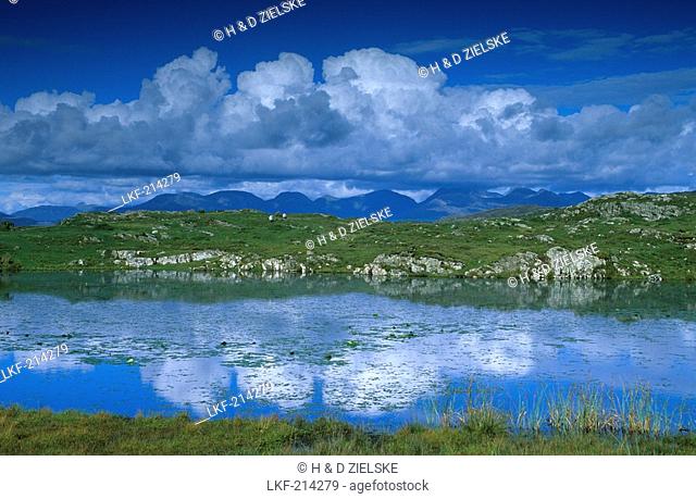 Twelve Bens mountain range and reflection of the clouds in a lake, Na Beanna Beola, Connemara, Co. Galway, Ireland, Europe