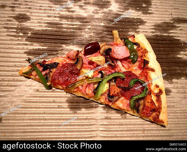slice of pizza on cardboard