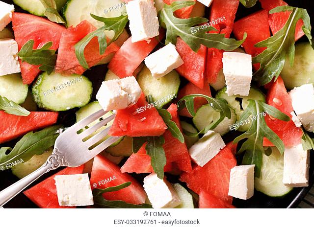 Background food: salad of watermelon, cheese and cucumbers macro. horizontal view from above