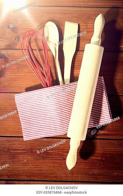 baking, cooking and home kitchen concept - close up of kitchenware set on wooden board from top