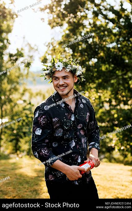 Smiling man wearing flower wreath