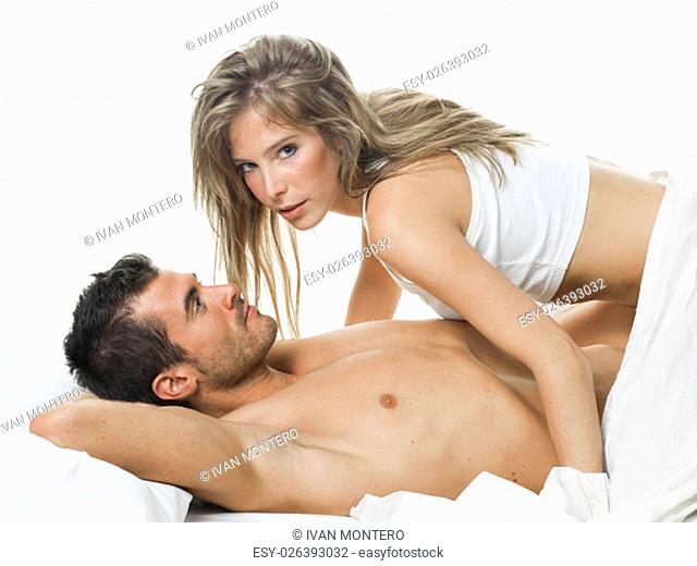 a man and a woman foreplaying in a white bed