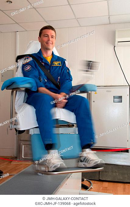 At the Cosmonaut Hotel crew quarters in Baikonur, Kazakhstan, Expedition 4041 Flight Engineer Reid Wiseman of NASA takes a ride in a spinning chair May 21 as he...