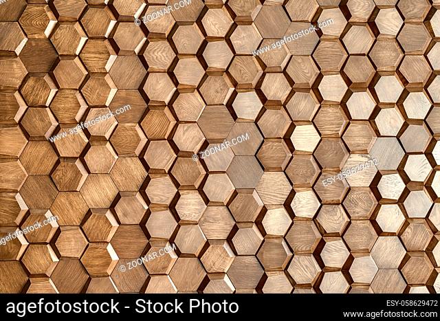 Wooden wall textured with a lot of the hexagons. Indoors. Horizontal