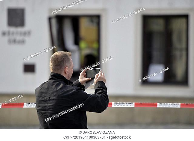 A man takes photos of the town hall in Rymarov on Wednesday, April 10, 2019, where an explosion rocked the whole of the first floor and the detonation broke the...