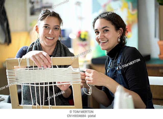 Portrait smiling young women friends making string picture frame