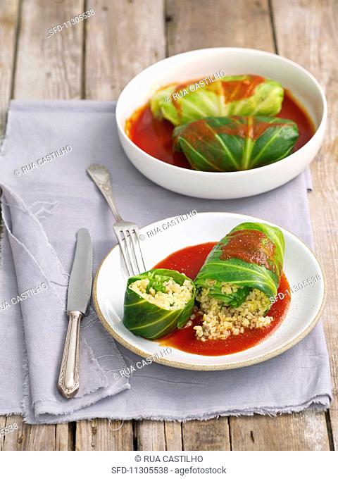 Cabbage parcels filled with bulgur and mushrooms in tomato sauce