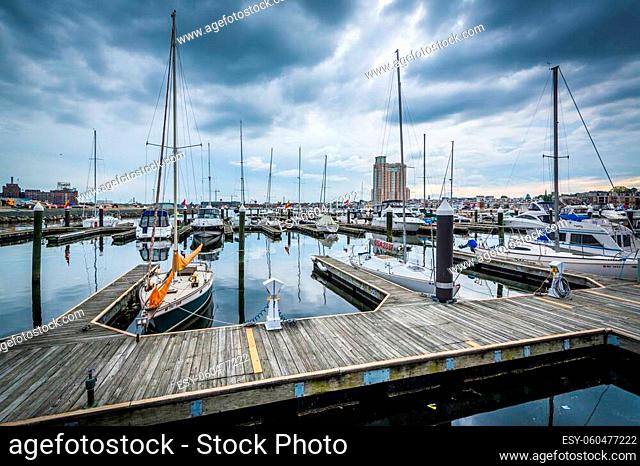 Storm clouds over docks and boats in Harbor East, Baltimore, Maryland