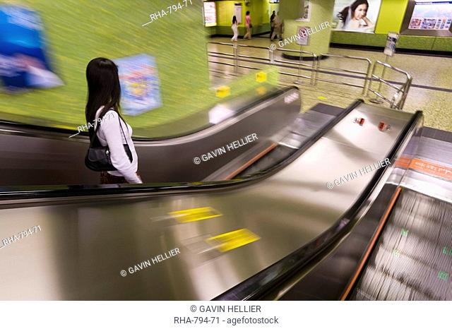 Commuter at MTR escalator underground subway metro station, Hong Kong, China, Asia