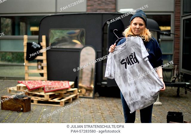 The initiator and fashion student Janine Coldewey poses with a self designed t-shirt in front of her mobile fashion store 'Trailer Trash', a converted trailer