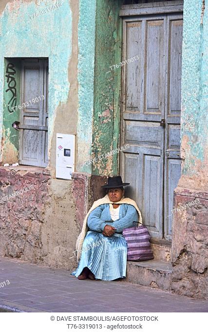 Cholita in a door frame, Potosí, Bolivia