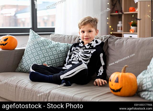 happy boy in halloween costume of skeleton at home