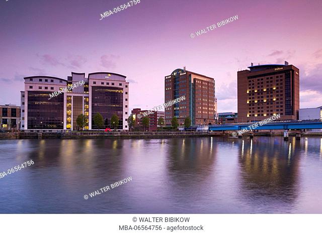 UK, Northern Ireland, Belfast, city skyline along River Lagan, dusk