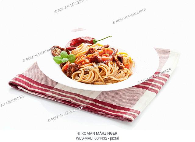 Linguini peperoncino rosso and pasta sauce in plate on napkin