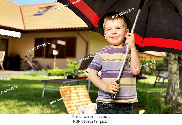 Image of a little kid with a big umbrella