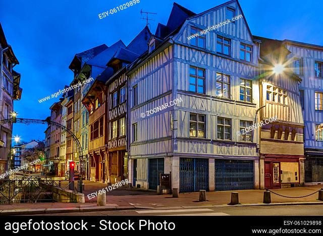 Street in historical center of Rouen with half-timbered houses, France. Evening