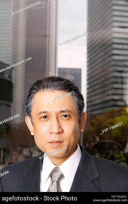 Portrait confident businessman in city