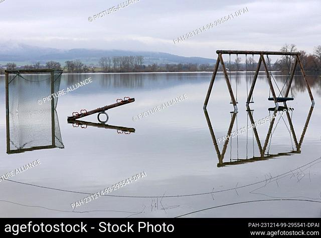 14 December 2023, Baden-Württemberg, Riedlingen: A playground is under water in the district of Bechingen. The flood situation remains tense in parts of...