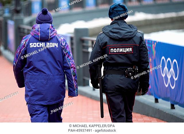 A uniformed policeman and a Sochi Security officer are seen in Krasnaya Polyana near Sochi, Krasnodar region, Russia, 31 January 2014