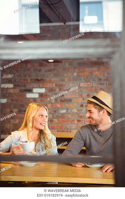 Smiling hipsters drinking coffee