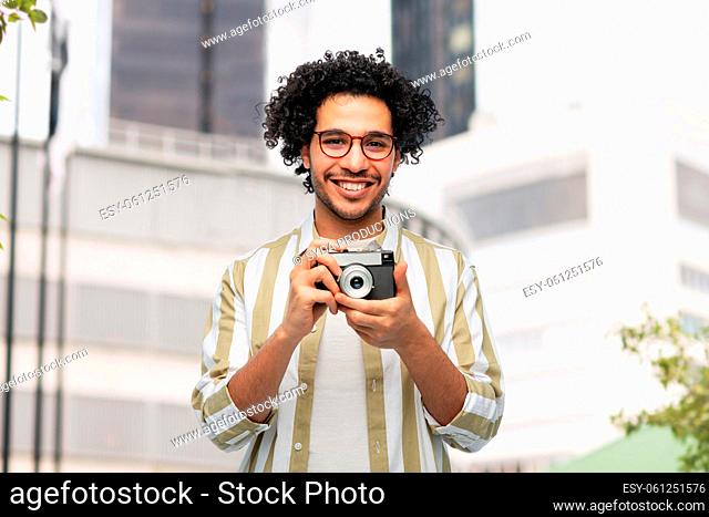 smiling man or photographer with film camera