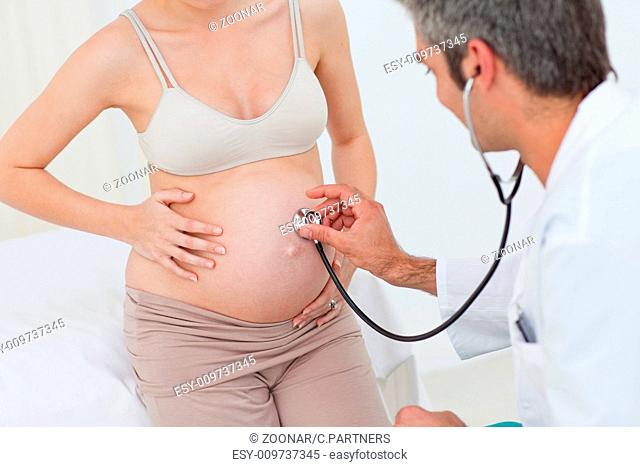 Portrait of a pregnant woman examined by her gynecologist