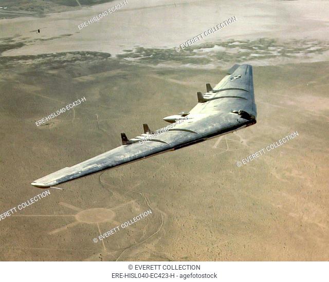 Aerial view of U.S. Air Force's 100-ton Northrop Flying Wing YB-49 jet bomber in flight, 1948. Flight testing revealed stability problems which could not be...
