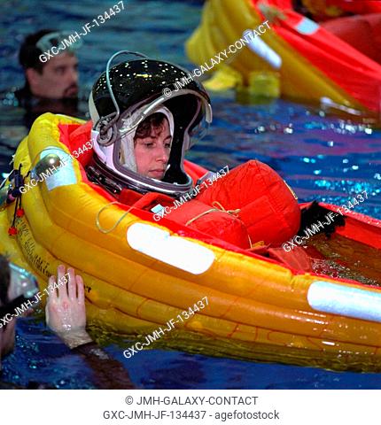 Astronaut Ellen Ochoa, mission specialist, has just deployed her life raft during emergency bailout training with her STS-96 crew mates