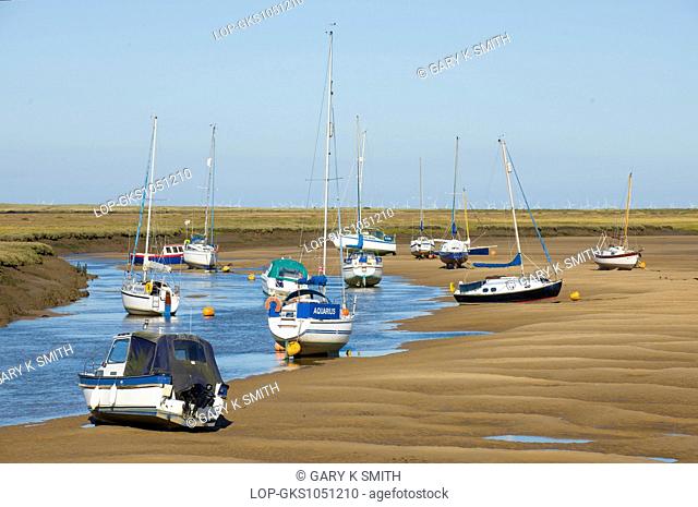 A view of Wells tidal harbour at low tide with pleasure craft looking north eastwards
