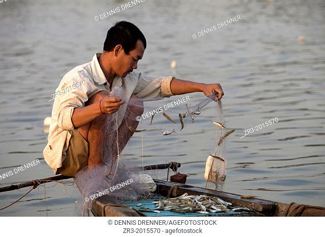 Fisherman work the Mekong River early in the morning outside of Phnom Penh, Cambodia
