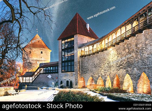 Tallinn, Estonia. Night Starry Sky Above Traditional Old Architecture Skyline In Old Town. Former Prison Tower Neitsitorn In Winter Evening Night