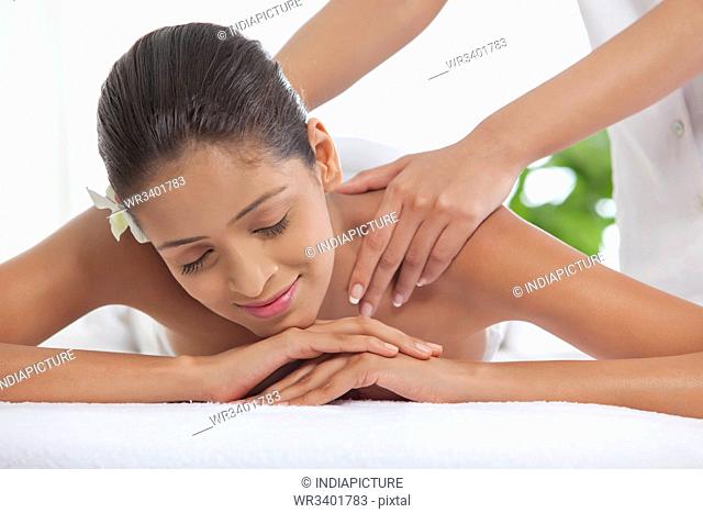 Young woman getting a back massage at spa