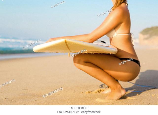 Beautiful female Surfer looking for the waves
