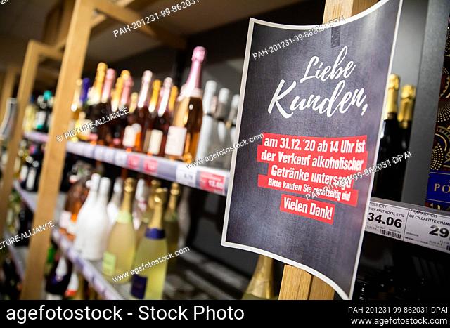 31 December 2020, Berlin: A sign hangs on a shelf in the beverage department of a supermarket in Berlin-Schöneberg shortly before the start of the ban on the...