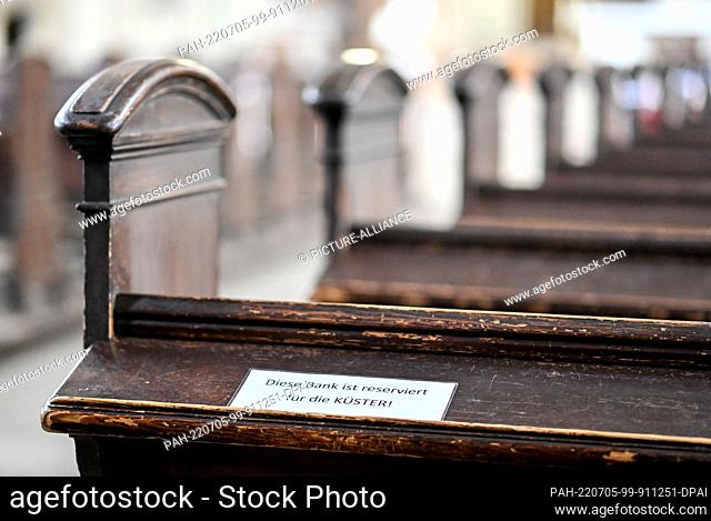 29 June 2022, Brandenburg, Potsdam: A note with the inscription ""This. Pew is reserved for the sextons"" in the Catholic Church of St. Peter and Paul