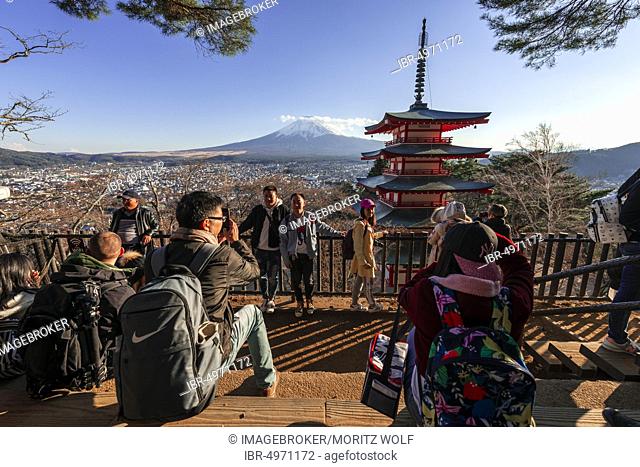 Tourists at a viewpoint, view of five-storey pagoda, Chureito pagoda with Fujiyoshida City and Mount Fuji volcano, Yamanashi Prefecture, Japan, Asia