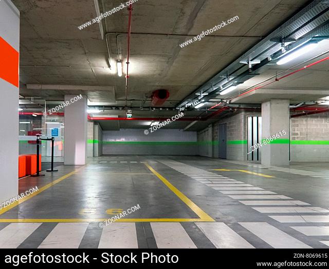 Parking garage underground, industrial interior. Neon light in bright industrial building