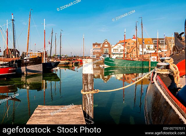 Urk Netherlands October 2020, Old histroical harbor on a sunny day, Small town of Urk village with the beautiful colorful lighthouse at the harbour by the lake...