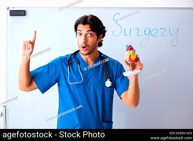 Young male doctor in front of whiteboard
