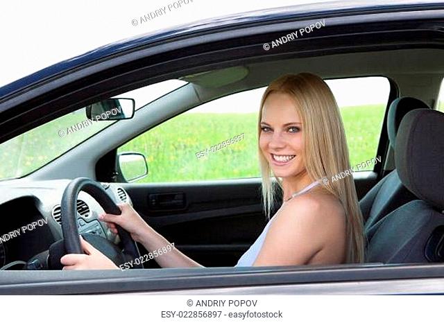 Happy Young Beautiful Woman Driving Car