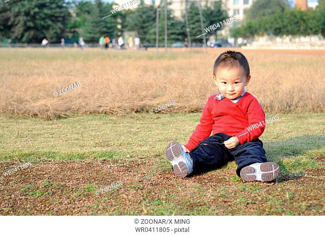 Cute little boy on grass