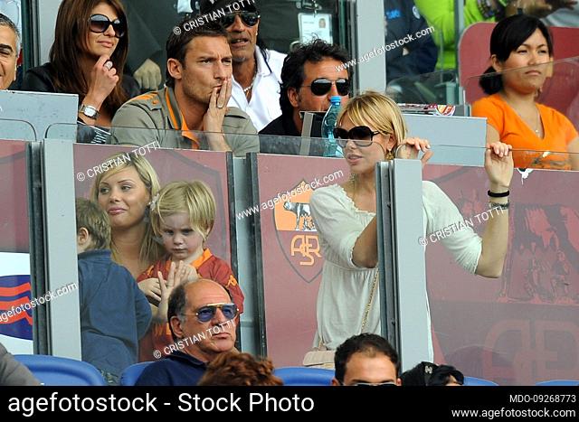Italian footballer Francesco Totti and his wife Ilary Blasi with their son Cristian in the stands at the Stadio Olimpico during the match Roma Cagliari
