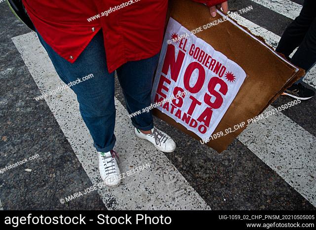 A demonstrator with a sign that reads ""The government is killing us"" on may 5, 2021 in Bogota, Colombia. After police brutality cases escalated to at least 19...