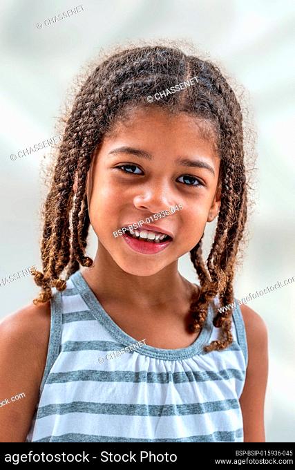 Little girl doing facial expressions face on white