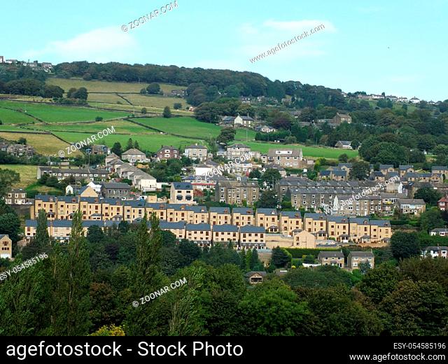 a row of modern houses build on a hillside surrounded by older buildings in sowerby bridge west yorkshire