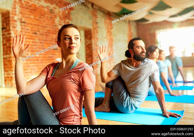 group of people doing yoga at studio