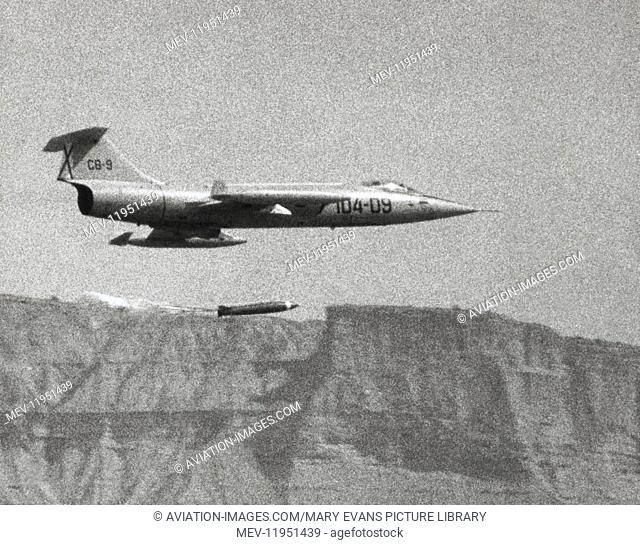 Spanish Airforce Lockheed F-104G Starfighter Flying Enroute and Dropping a Bomb with a Parachute Attached