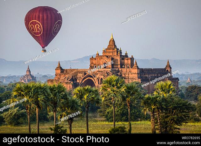 Hot air balloon in the air above a temple in Mandalay
