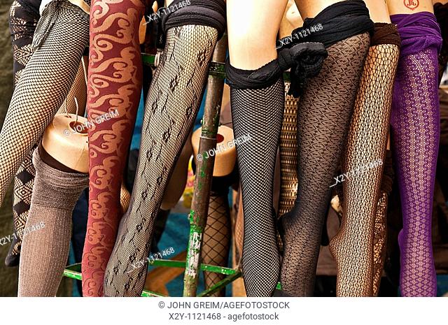 Mannequin legs model stockings in an outdoor market
